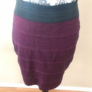 Stretchy Plum colored with a black banded waist.